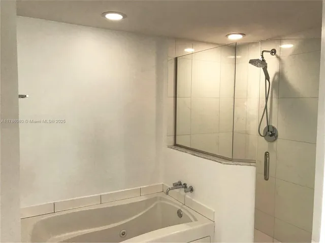 a bathroom with a shower and a tub