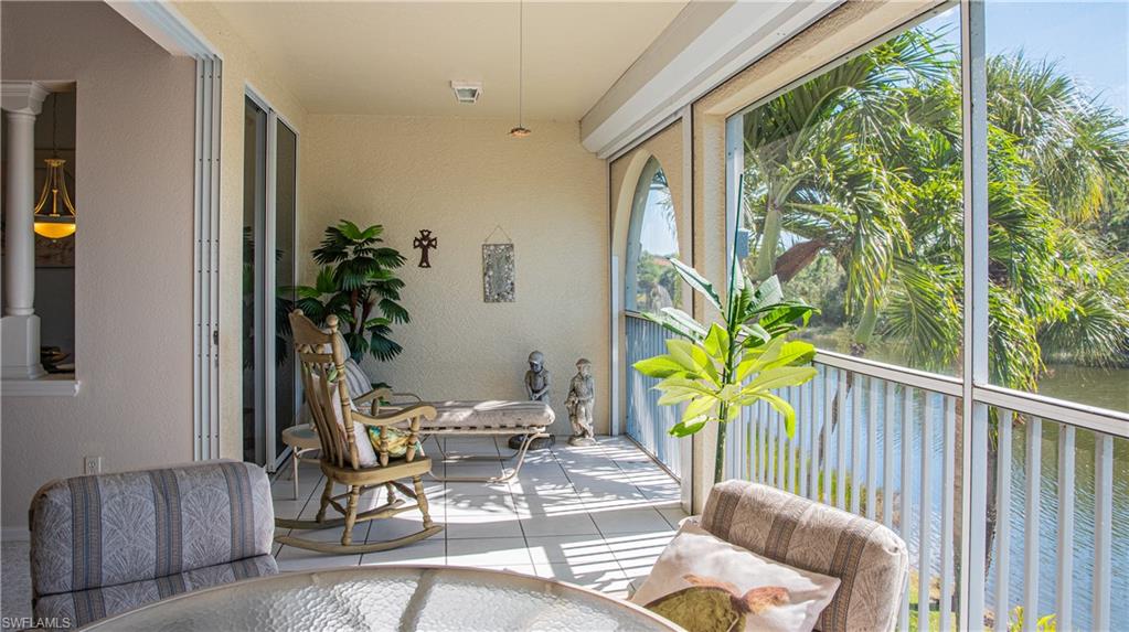 10711 Crooked River Road, Unit 202 Estero, FL 34135 - Photo 11 of 28 a balcony with furniture and potted plants
