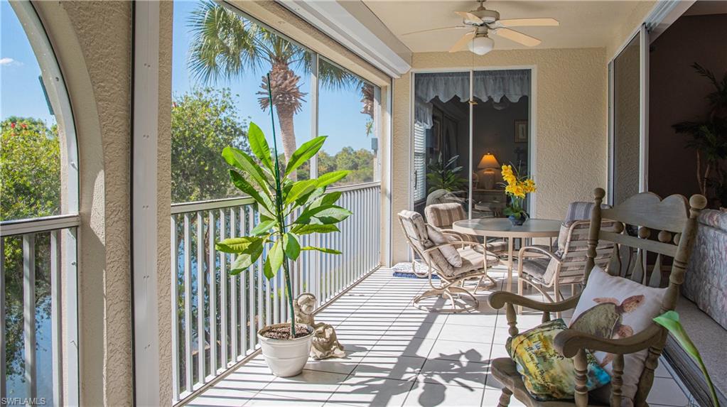 10711 Crooked River Road, Unit 202 Estero, FL 34135 - Photo 12 of 28 a vase of flowers sitting on a table in front of a window