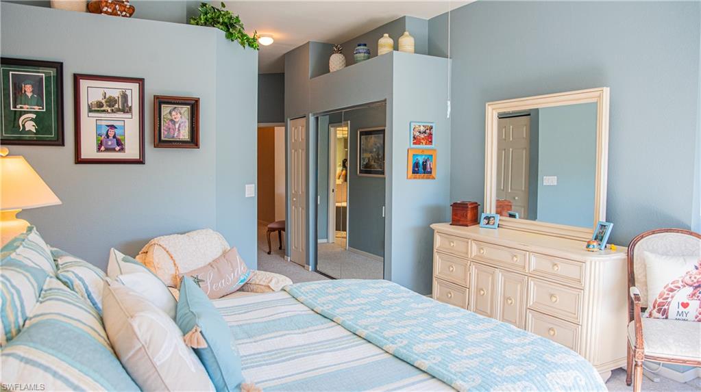 10711 Crooked River Road, Unit 202 Estero, FL 34135 - Photo 14 of 28 a bedroom with a bed and a dresser