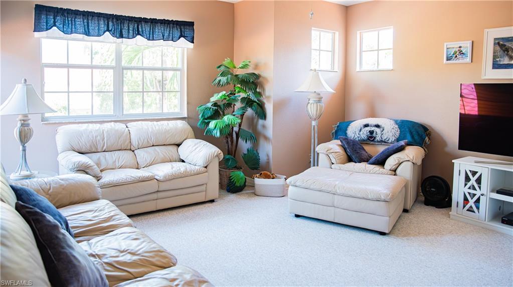 10711 Crooked River Road, Unit 202 Estero, FL 34135 - Photo 18 of 28 a living room with furniture and a large window