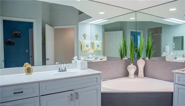 a en suite bathroom with a sink double vanity and a mirror