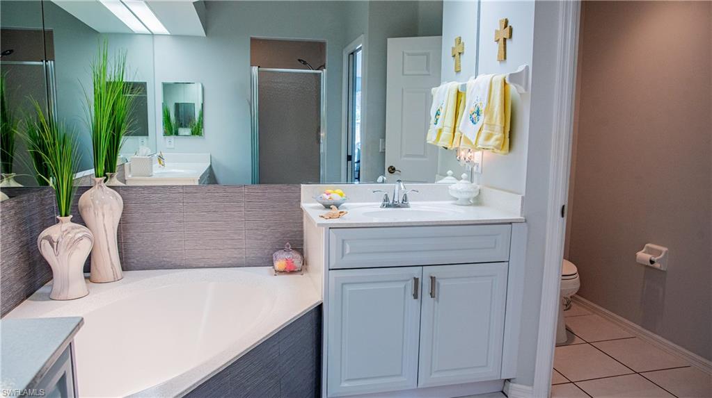 10711 Crooked River Road, Unit 202 Estero, FL 34135 - Photo 21 of 28 a en suite bathroom with a sink and a mirror