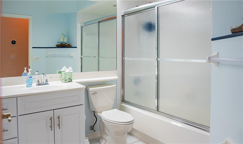 10711 Crooked River Road, Unit 202 Estero, FL 34135 - Photo 22 of 28 a bathroom with a sink toilet and shower