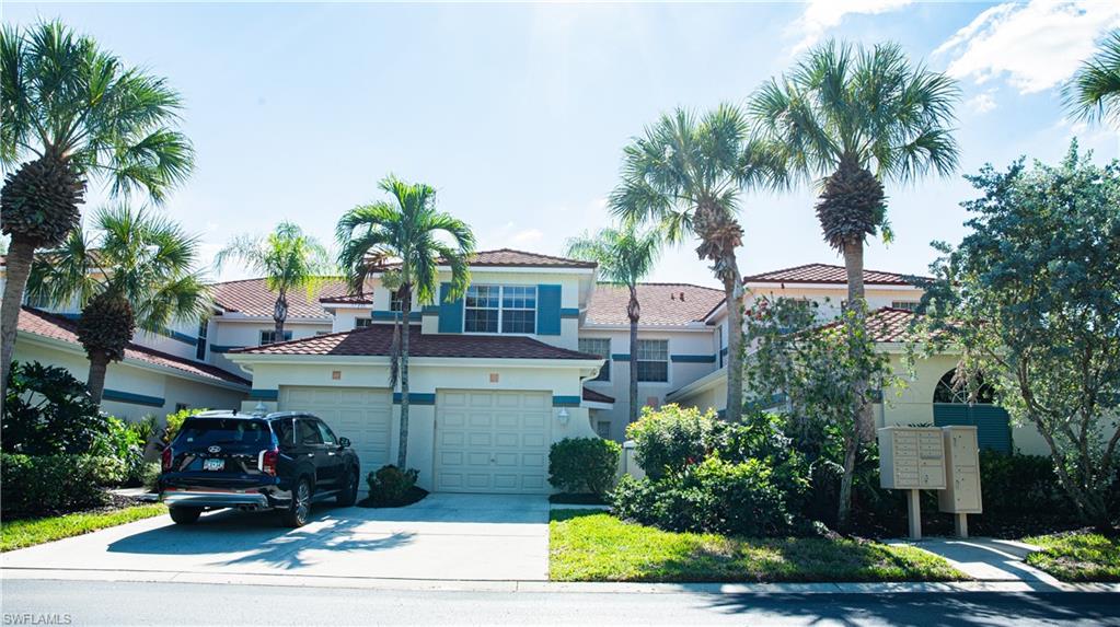 10711 Crooked River Road, Unit 202 Estero, FL 34135 - Photo 26 of 28 a front view of a house with garden