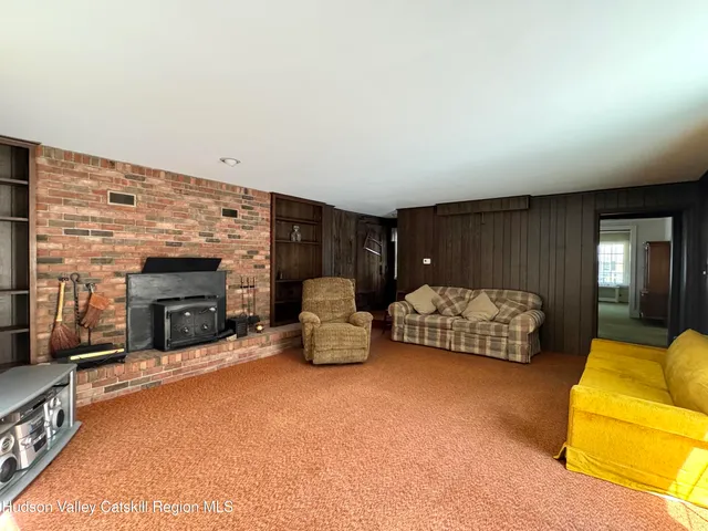 a bedroom with furniture and a fireplace