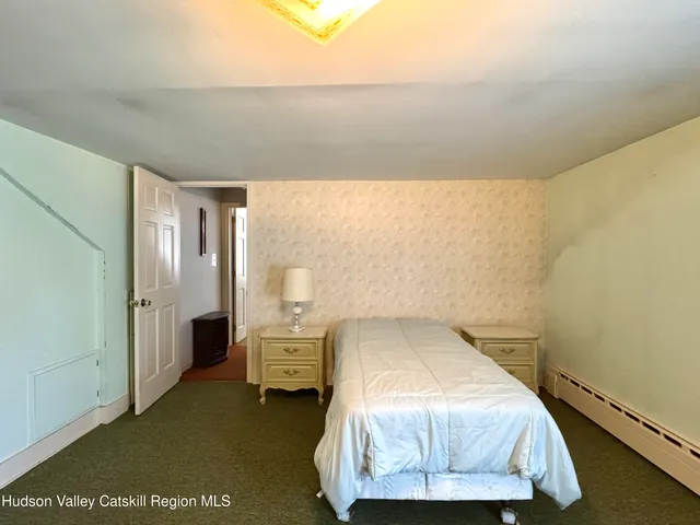 a bedroom with a bed and a night stand