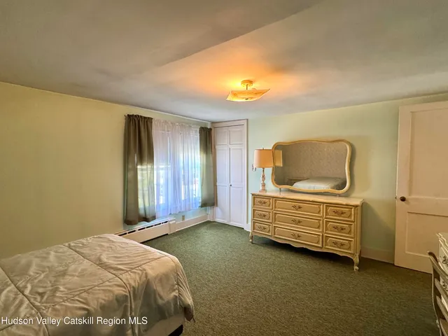 a bedroom with a bed and cabinets