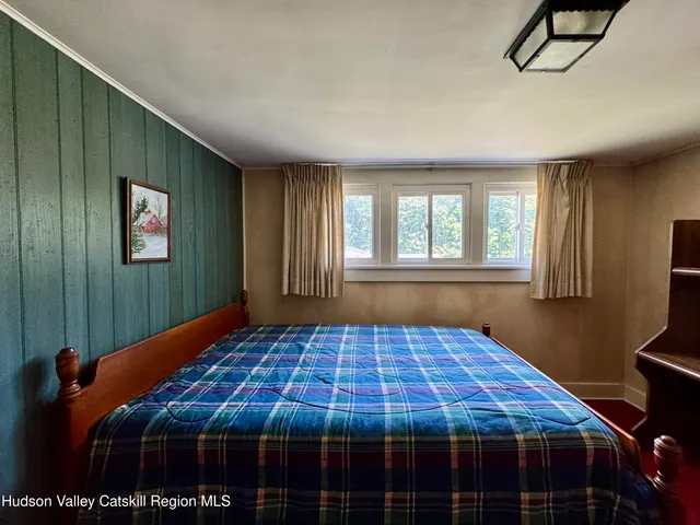 a bedroom with a bed and window