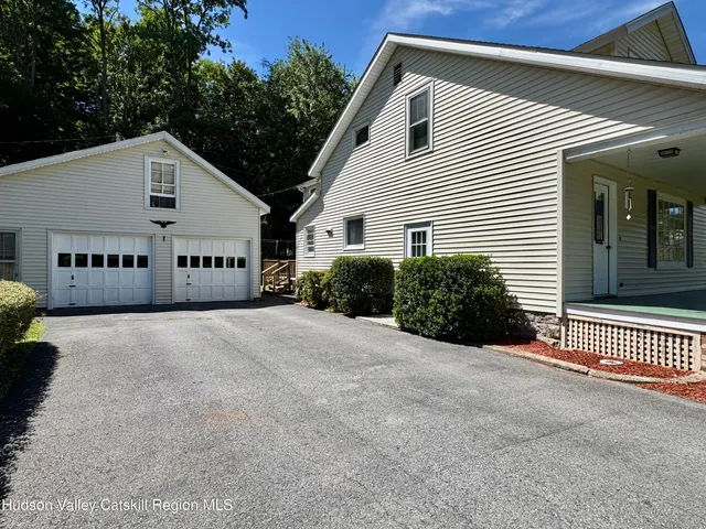 a view of a house with a yard and garage