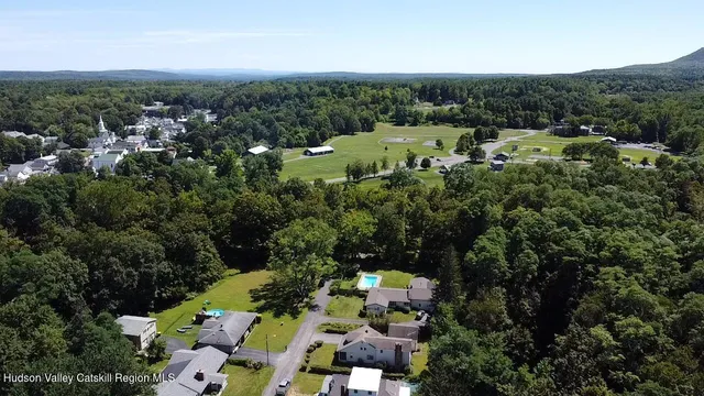 an aerial view of a houses with a yard