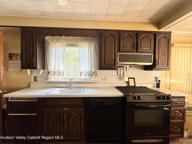 a kitchen with a sink stove and cabinets