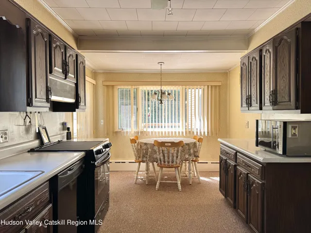 a view of a kitchen with granite countertop a sink and a stove