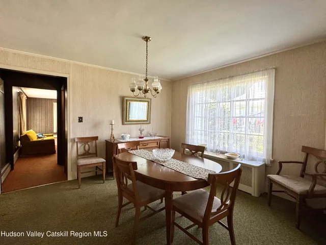 a view of a dining room with furniture window and outside view
