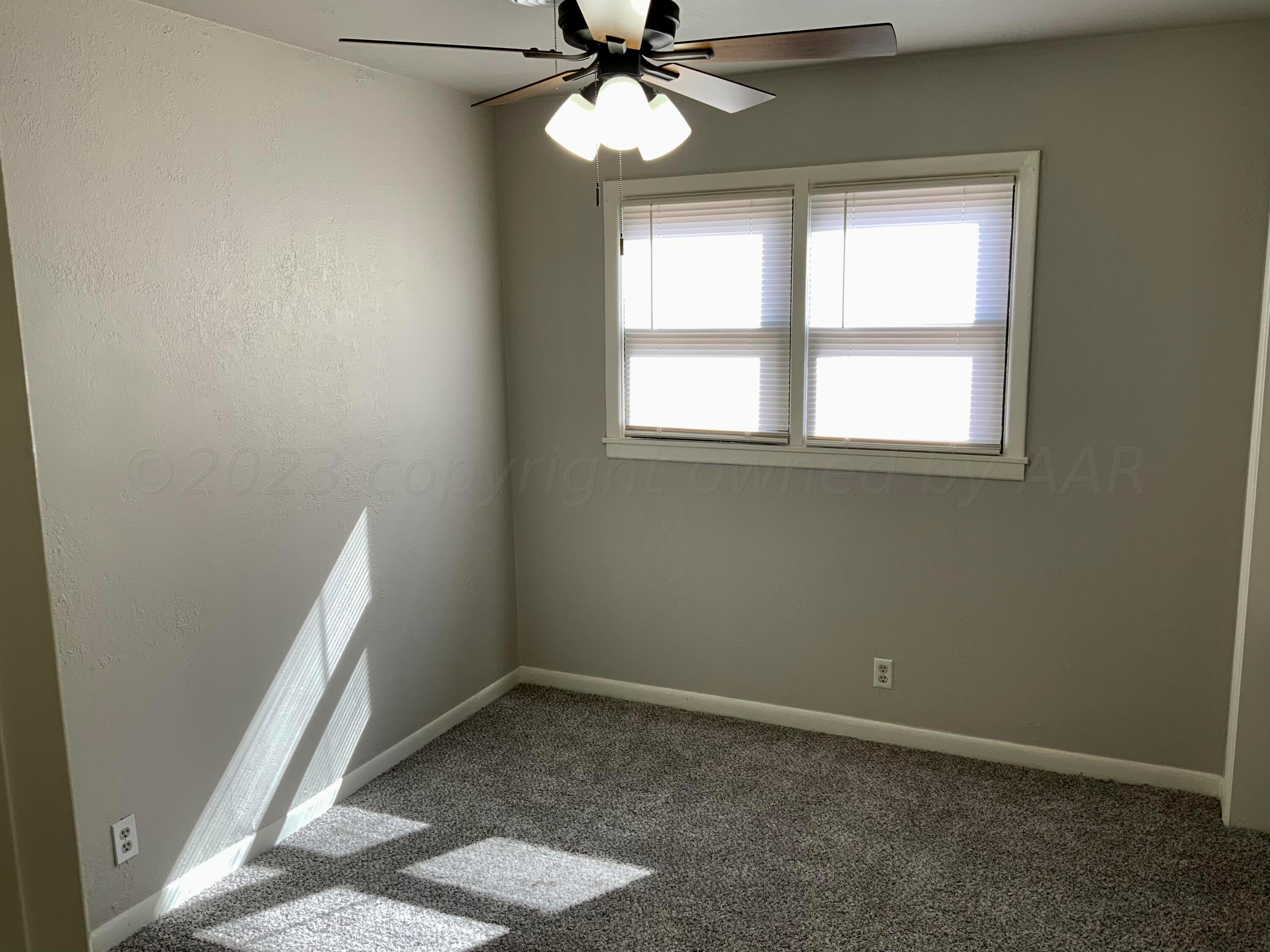 4616 South Rusk Street Amarillo, TX 79110 - Photo 17 of 25 an empty room with a window and a fan