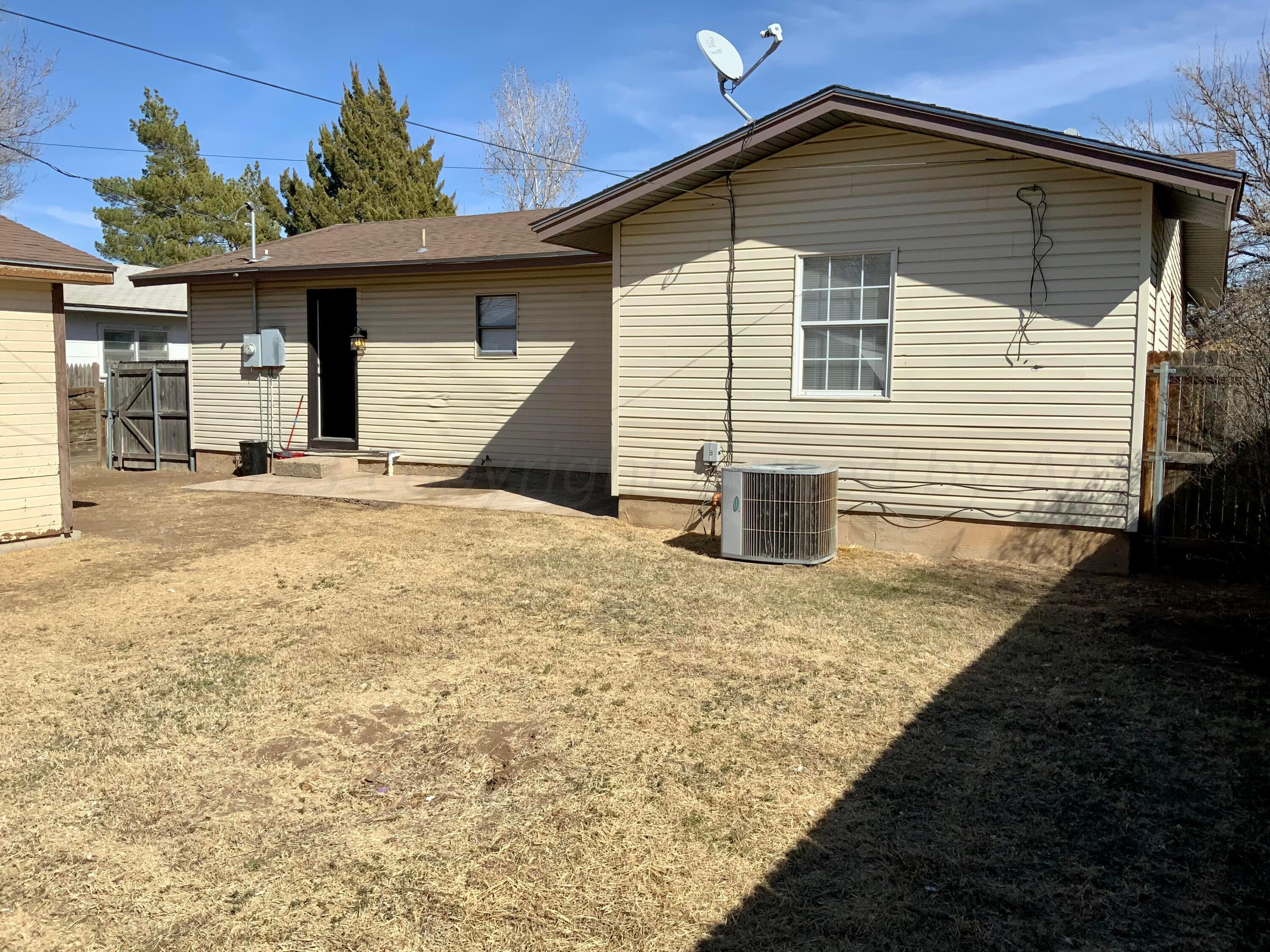 4616 South Rusk Street Amarillo, TX 79110 - Photo 20 of 25 a front view of a house with a yard