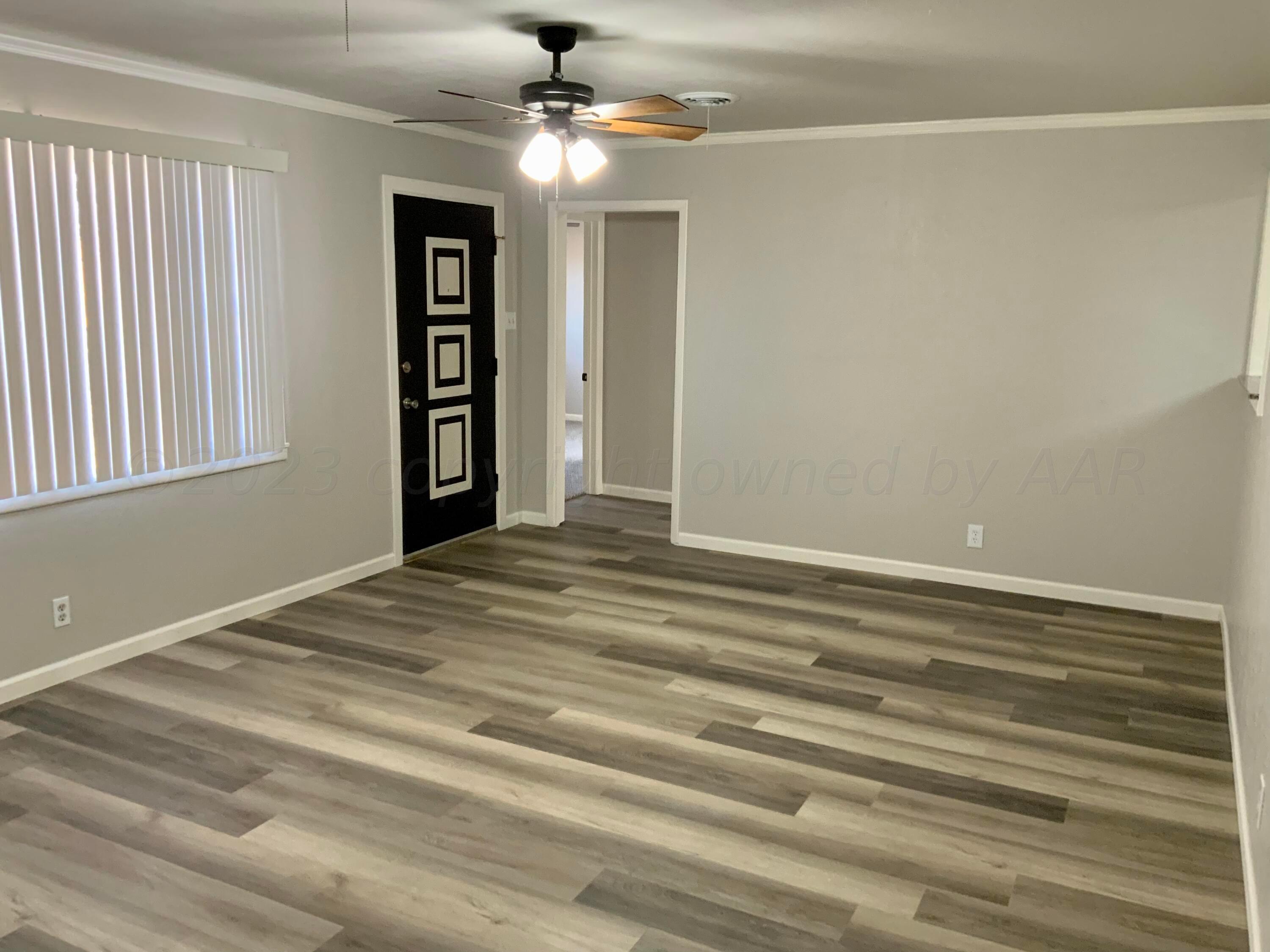 4616 South Rusk Street Amarillo, TX 79110 - Photo 6 of 25 a view of empty room with window and ceiling fan