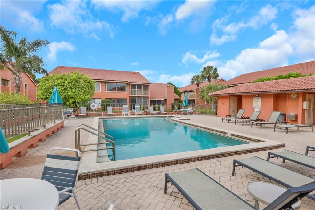 120 Cypress Way East, Unit B5 Naples, FL 34110 - Photo 21 of 24 Community pool featuring a patio
