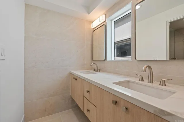 a bathroom with a double vanity sink and mirror