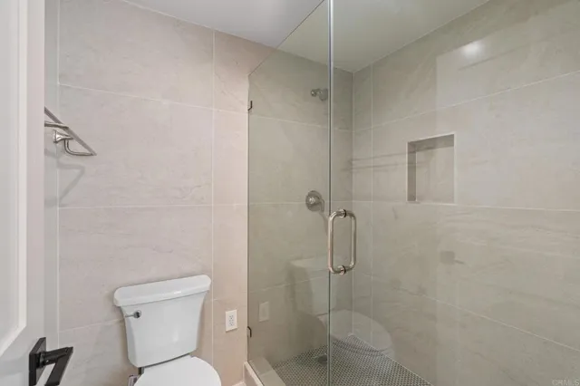 a bathroom with a toilet and a shower