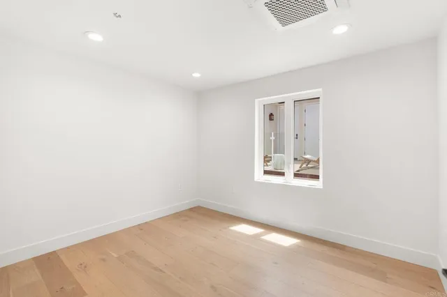 an empty room with windows and closet