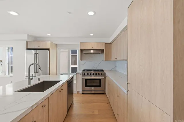a kitchen with white cabinets and a stove