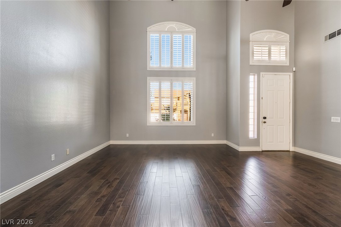 261 Timber Hollow Street Henderson, NV 89012 - Photo 8 of 51 A spacious entry features gleaming hardwood flooring and an abundance of natural light.