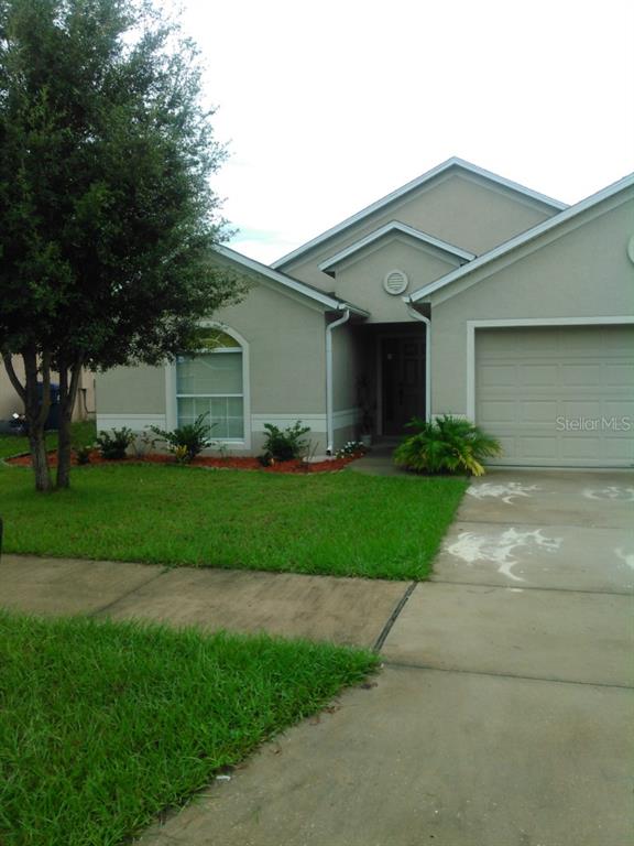 2018 Newtown Road Groveland, FL 34736 - Photo 1 of 1 a front view of a house with a garden and yard