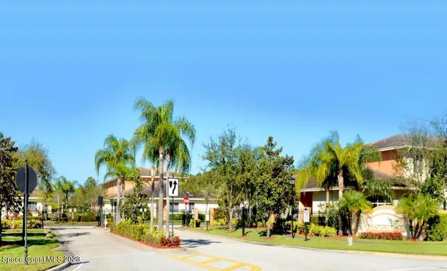 a view of a street with a building and a street sign