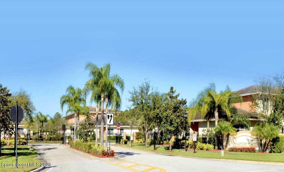 a view of a street with a building and a street sign