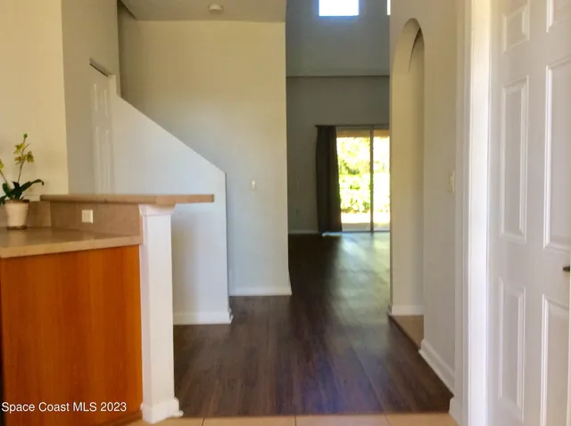 a view of hallway with wooden floor