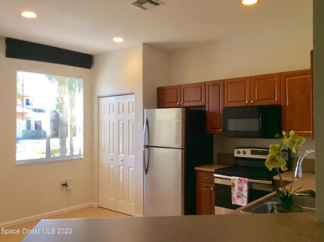 a kitchen with stainless steel appliances a refrigerator and a stove top oven