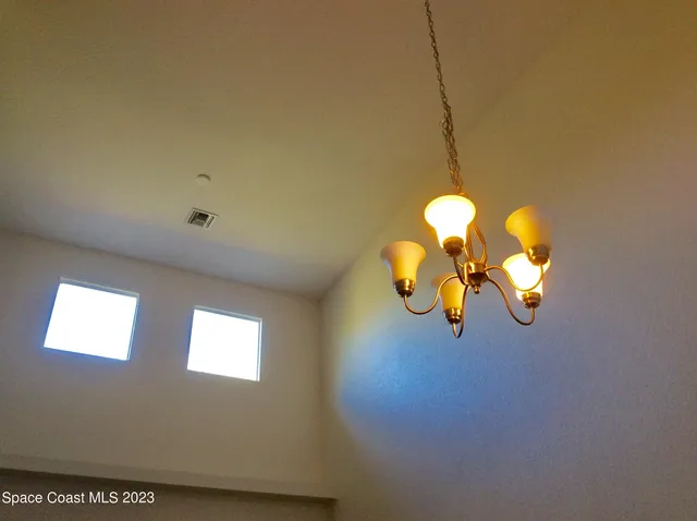 a view of a bathroom with a sink and a chandelier