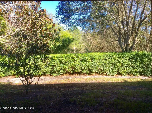 an aerial view of residential houses with outdoor space and lake view