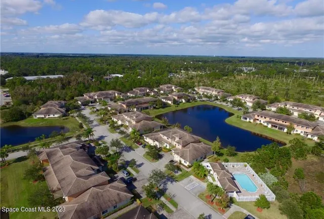 an aerial view of a house with a garden and swimming pool