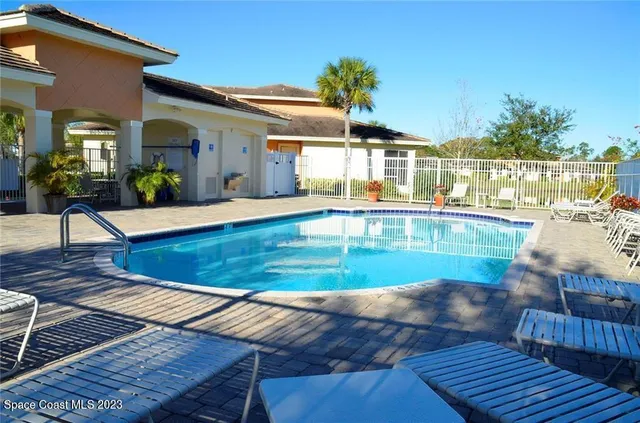 swimming pool view with outdoor seating