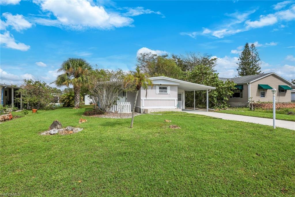 171 Grassy Key Lane, Unit 48 Naples, FL 34114 - Photo 19 of 19 a front view of house with yard and green space