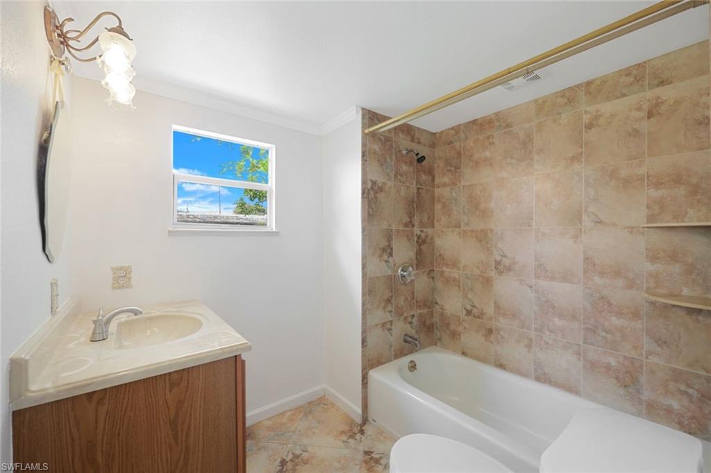 171 Grassy Key Lane, Unit 48 Naples, FL 34114 - Photo 10 of 19 a bathroom with a sink toilet and shower