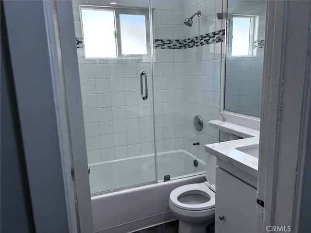 a bathroom with a shower a toilet and a sink