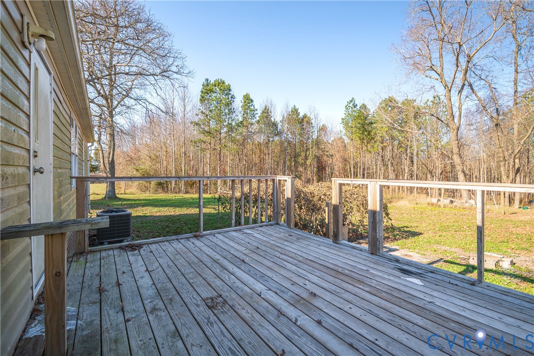 14306 Wilkinson Road Dewitt, VA 23840 - Photo 38 of 60 Wood deck with railing overlooking a grassy area a