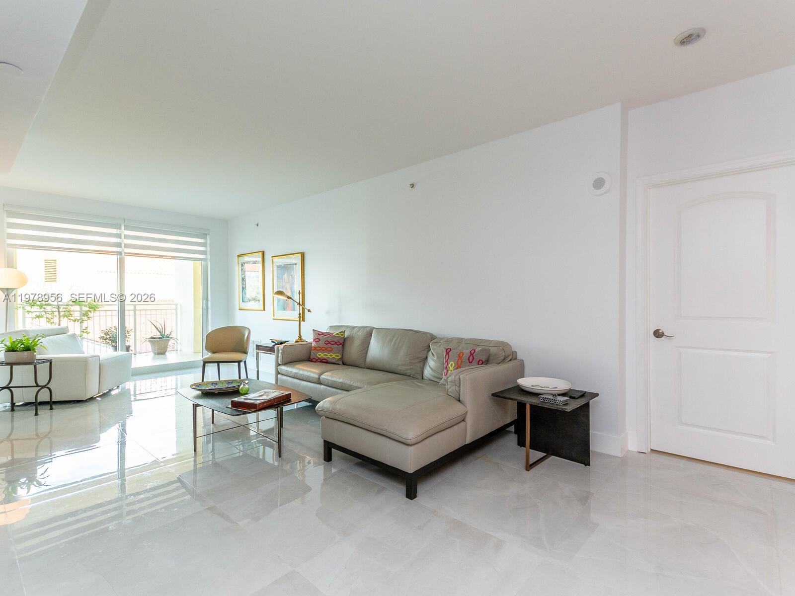 7350 Southwest 89th Street, Unit 719S Miami, FL 33156 - Photo 9 of 30 a living room with furniture and a large window