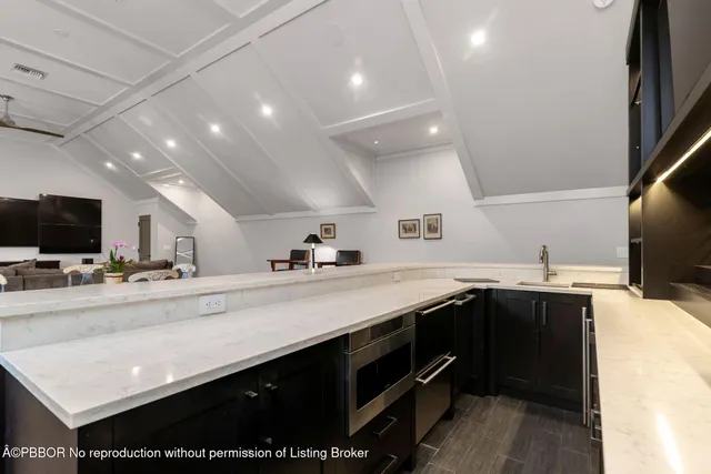 a kitchen with a sink stainless steel appliances and cabinets