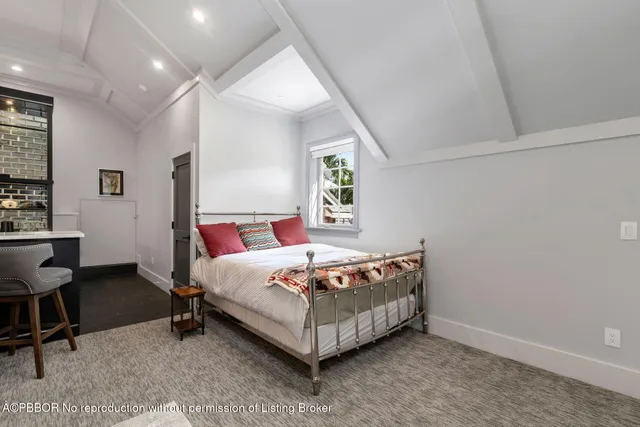 a bedroom with a bed lamp and a window