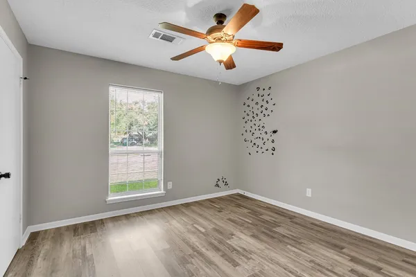 wooden floor in an empty room with a window