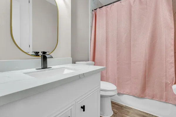 a bathroom with a sink a toilet and a mirror
