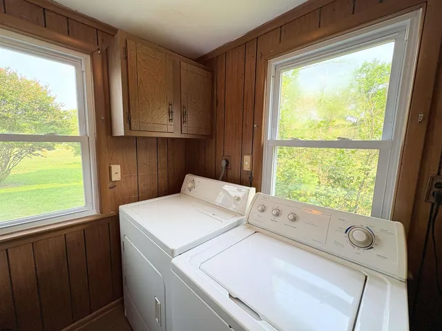 a view of staircase with wooden floor and white walls