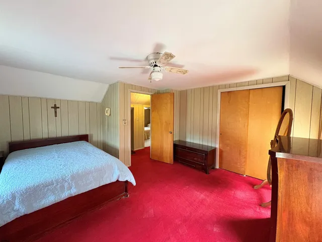 a bedroom with a large bed and a window