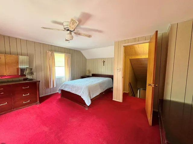 a bedroom with a bed and a dresser in it