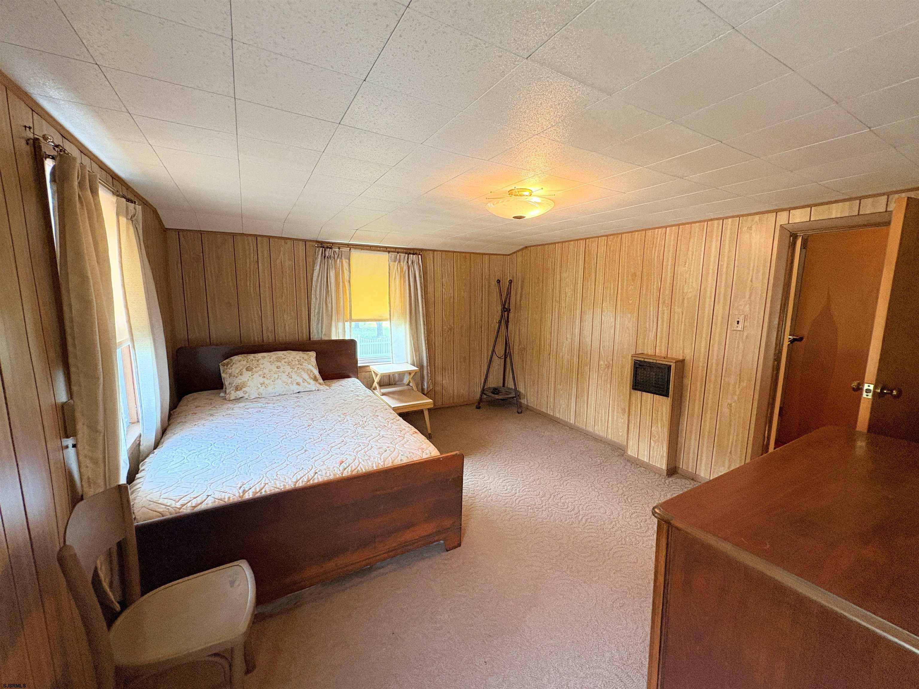 301 Broad Street Milmay, NJ 08330 - Photo 30 of 64 a spacious bedroom with a bed and a dresser with wooden floor