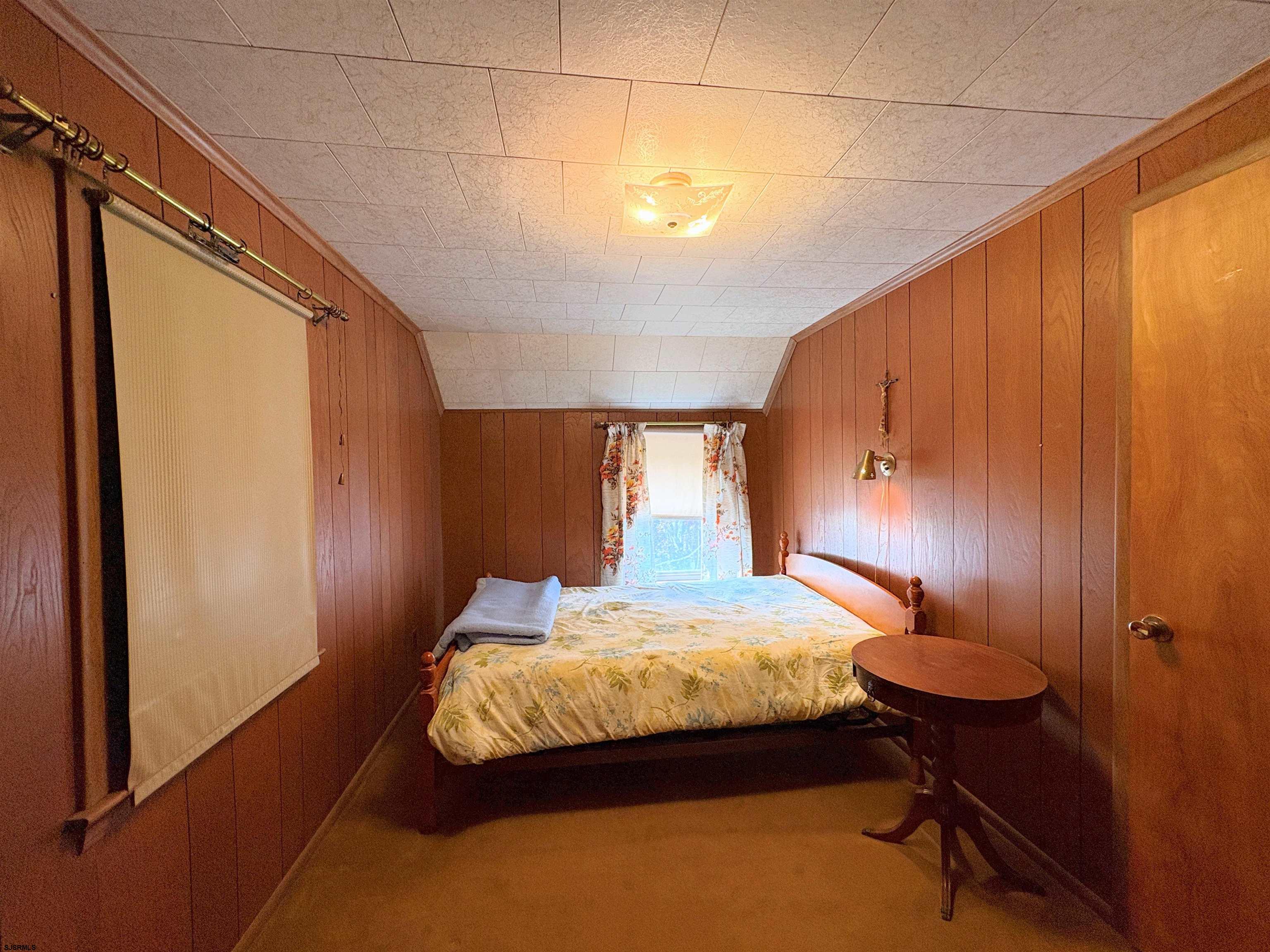 301 Broad Street Milmay, NJ 08330 - Photo 36 of 64 a bedroom with a bed and a chandelier